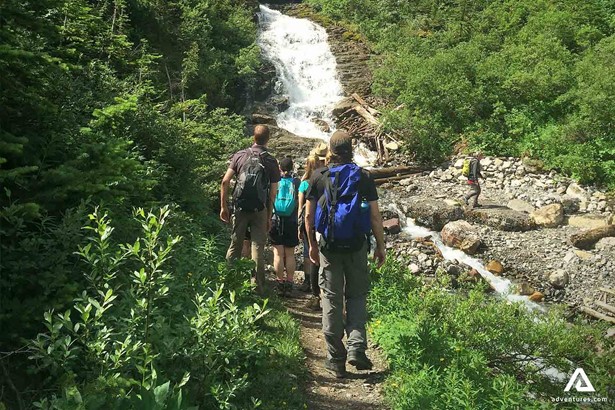 Group Hiking to Waterfall In Rocky Mountains