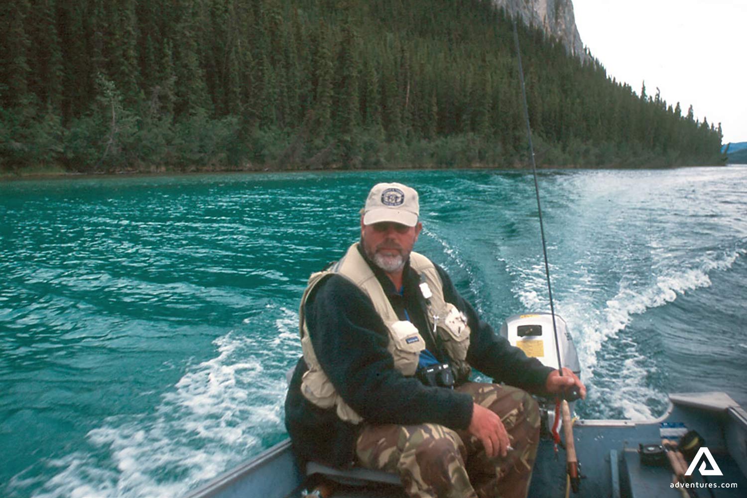 Man Fishing on a Blue Lake in Canada