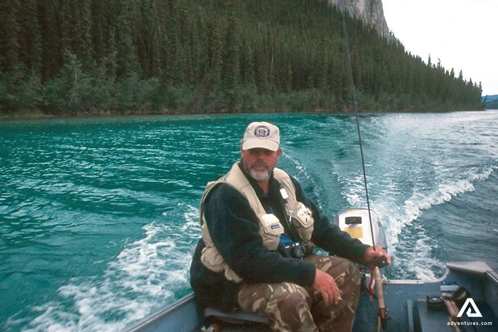 Man Fishing on a Blue Lake