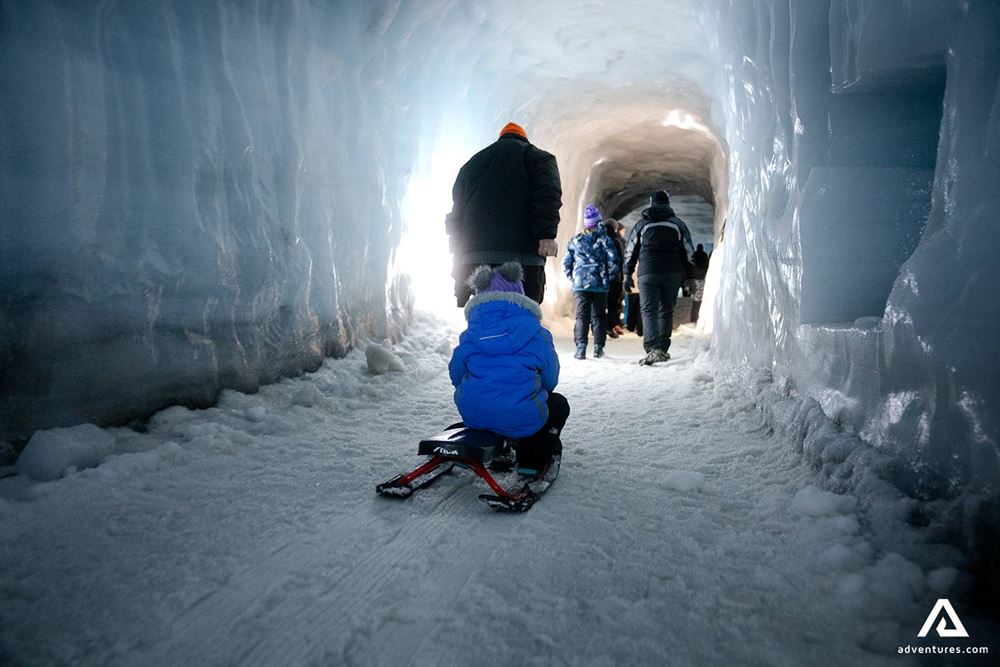 Tourists Walking in Ice Tunnel