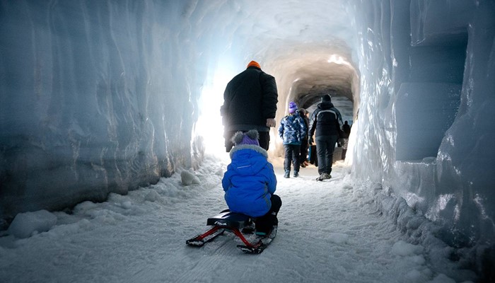 Tourists Walking in Ice Tunnel in Iceland