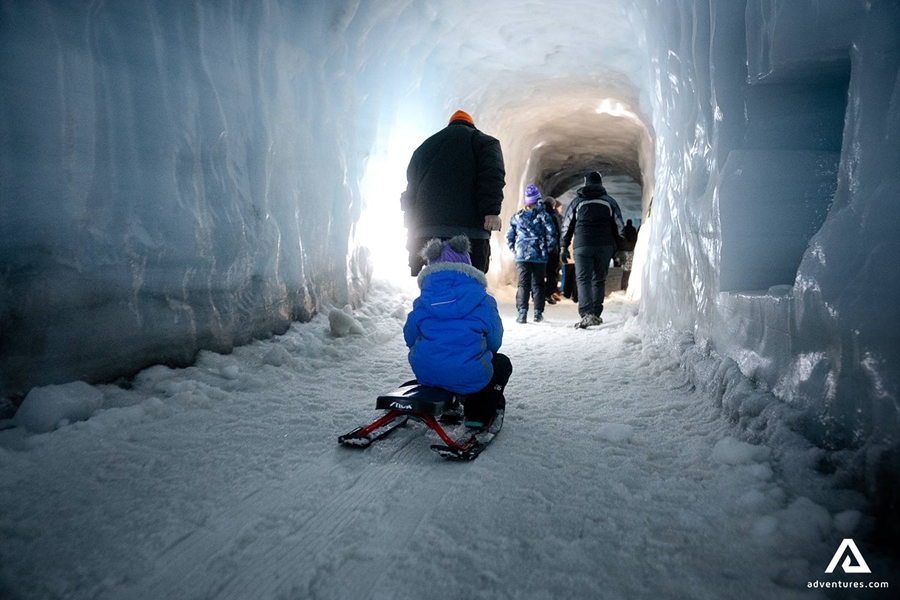 Tourists Walking in Ice Tunnel