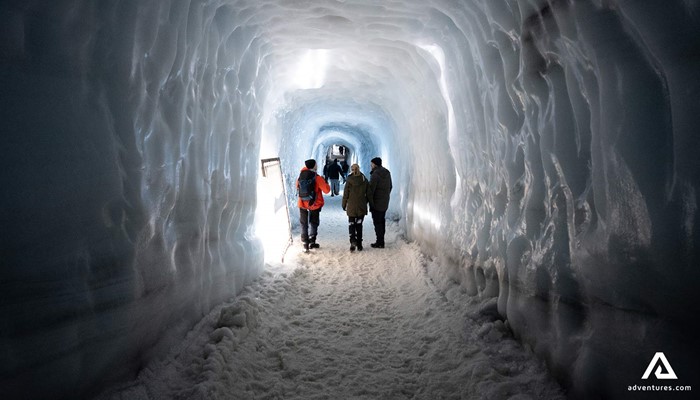 People Exploring Ice Tunnel in Iceland