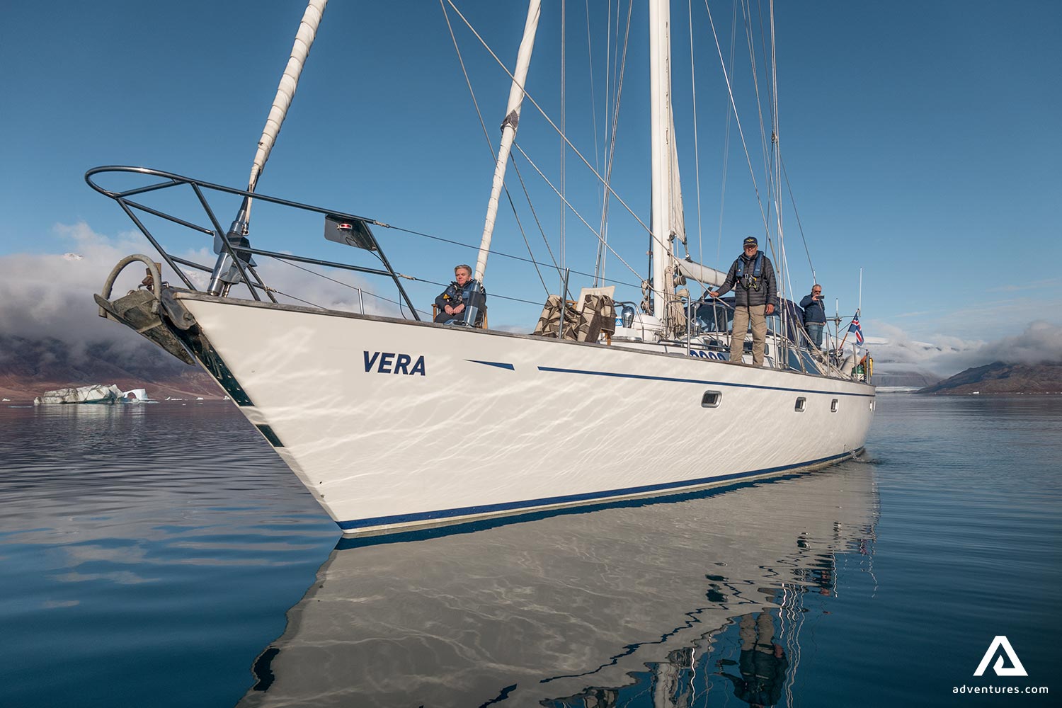 Sailors Swimming with White Yacht in Greenland
