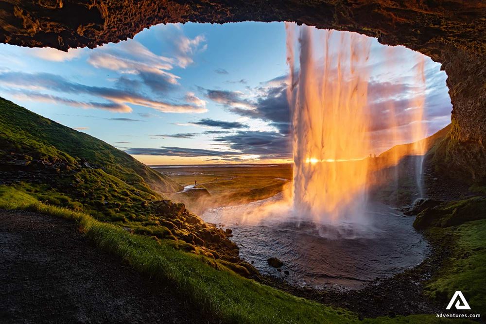 View Behind Waterfall at Sunset