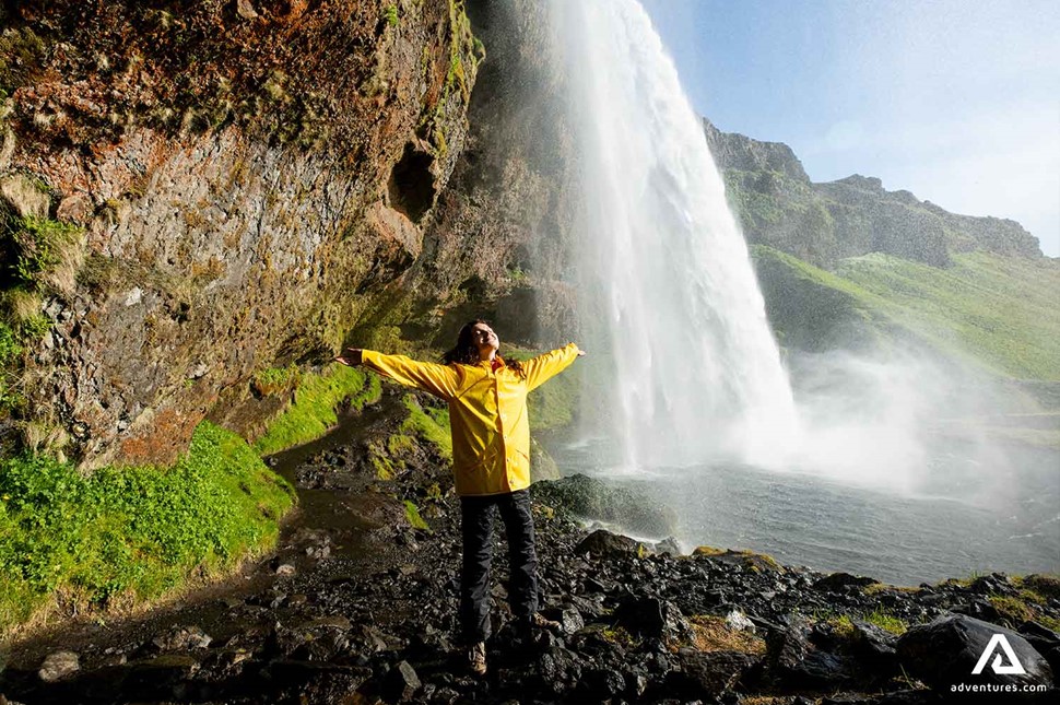 Woman Enjoys Waterfall in Iceland