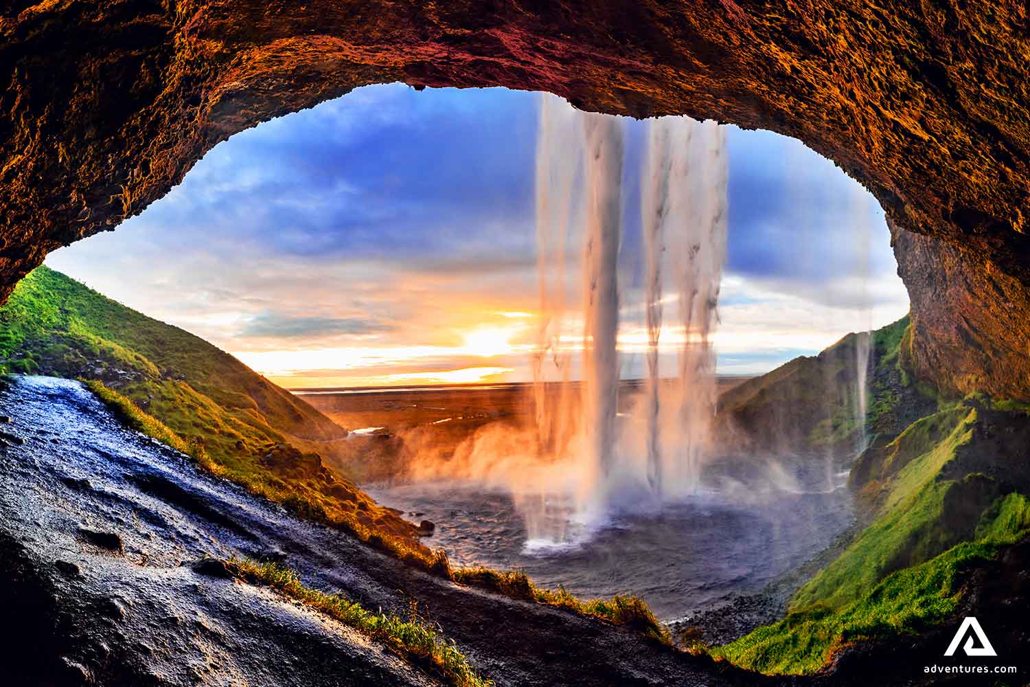 Seljalandsfoss Waterfall from Behind at Sunset