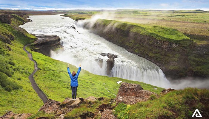 Happy Woman at Gullfoss Waterfall in Iceland