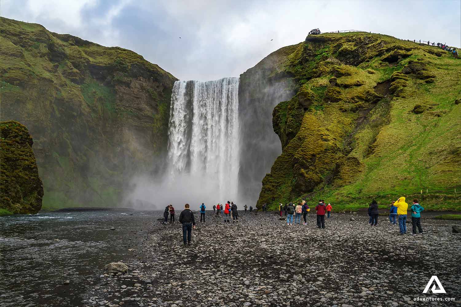 People Walking by Skogafoss Waterfall