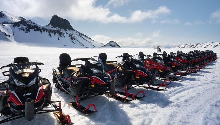 Snowmobiles Standing in Row on Glacier