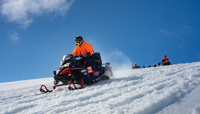 People Riding Snowmobiles in Iceland