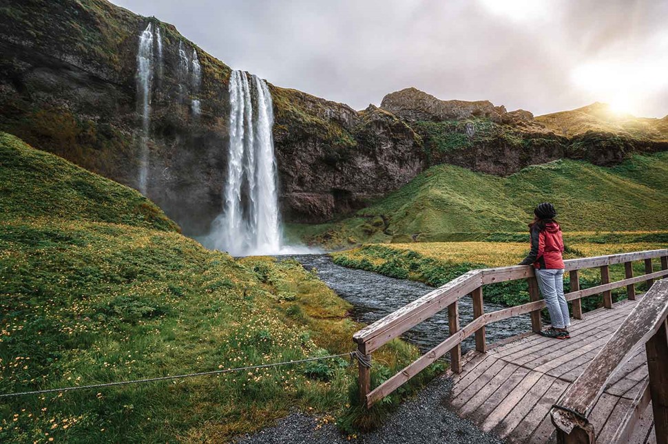 Woman Observing A Waterfall In Iceland Golden Circle