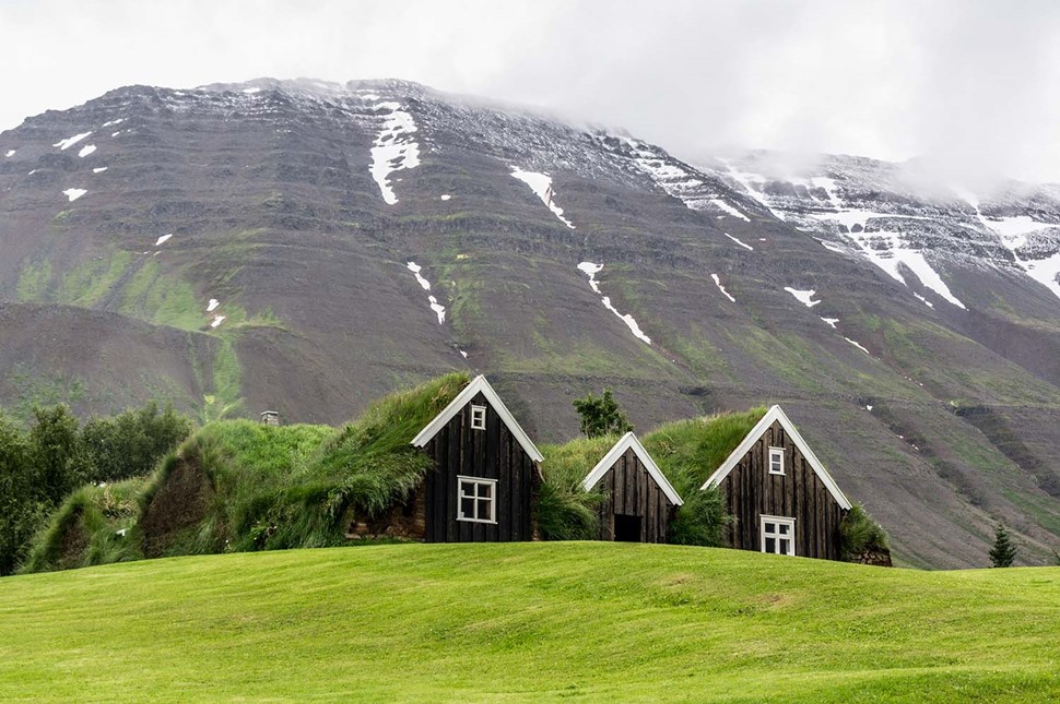 Icelandic Green Turf Houses Covered With Grass Standing Around Mountains