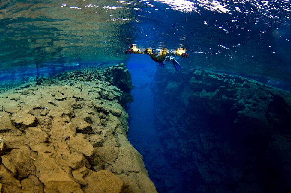Snorkeling between two tectonic plates in a blue water