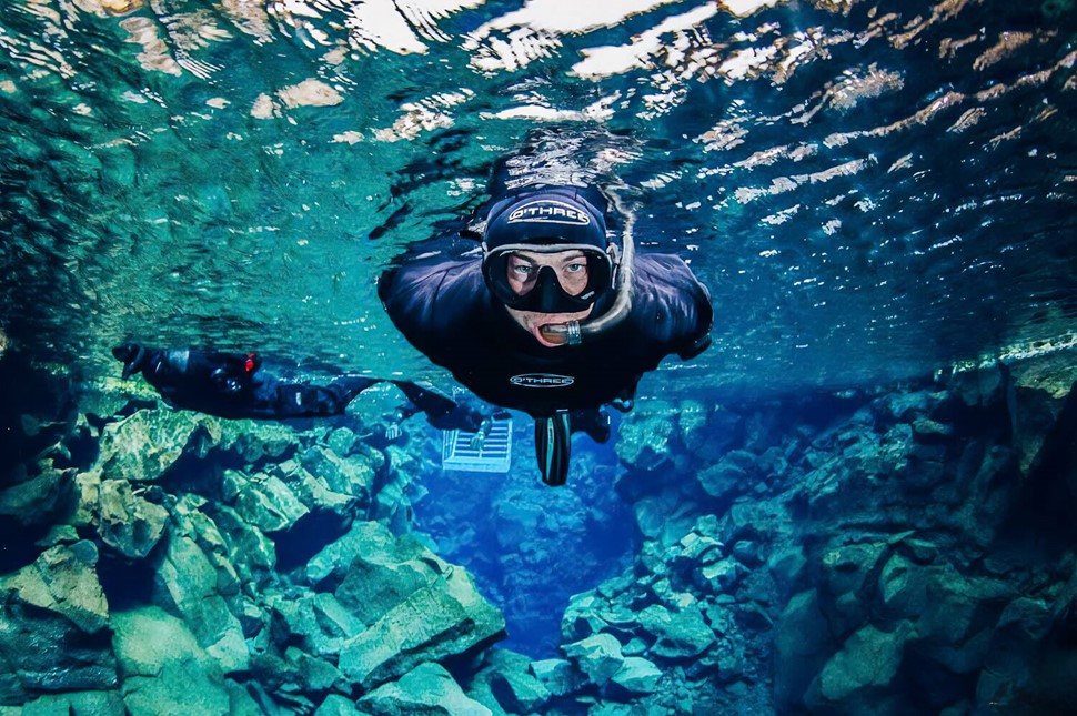 Person who snorkels in between two tectonic plates