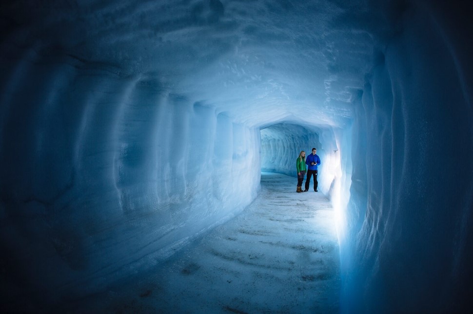 Couple inside glacier tunnel 