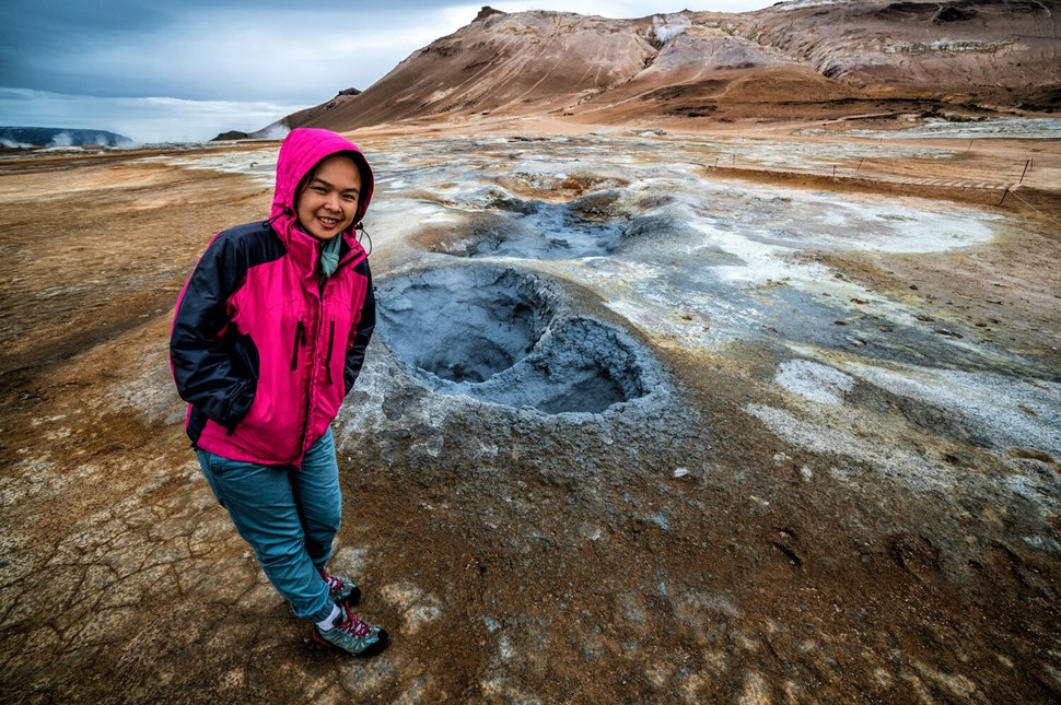 Tourist standing by fumarole