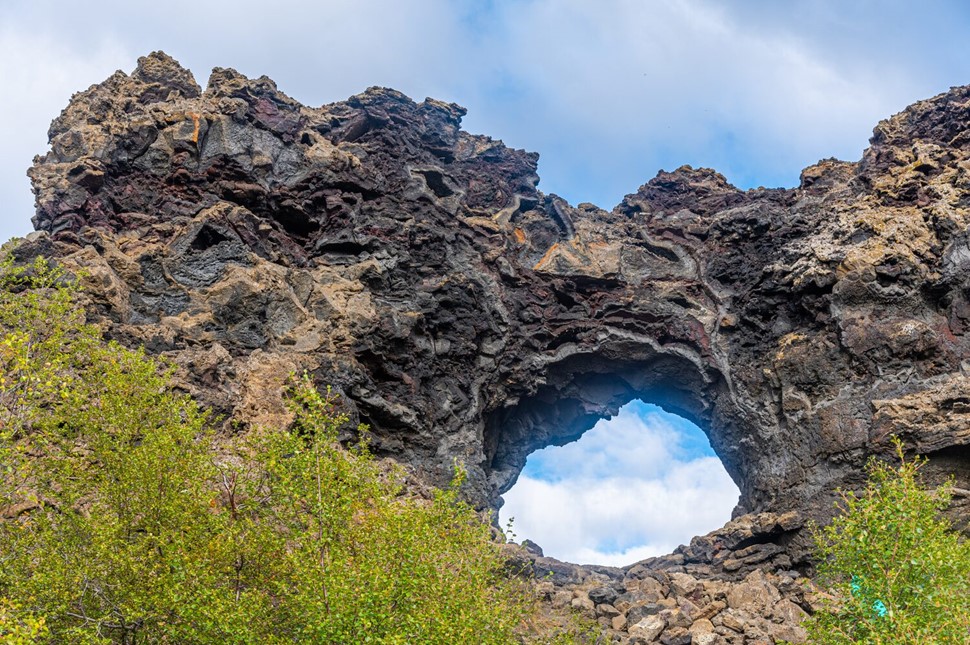 Dimmuborgir lava arch against blue skies