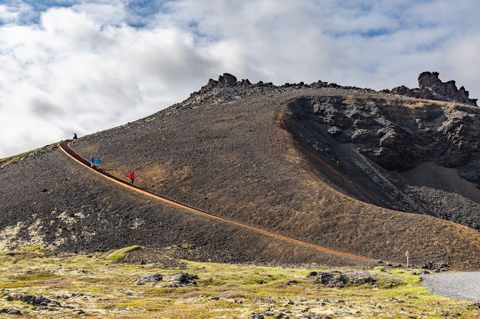 Hikers descending Saxholl crater staircase