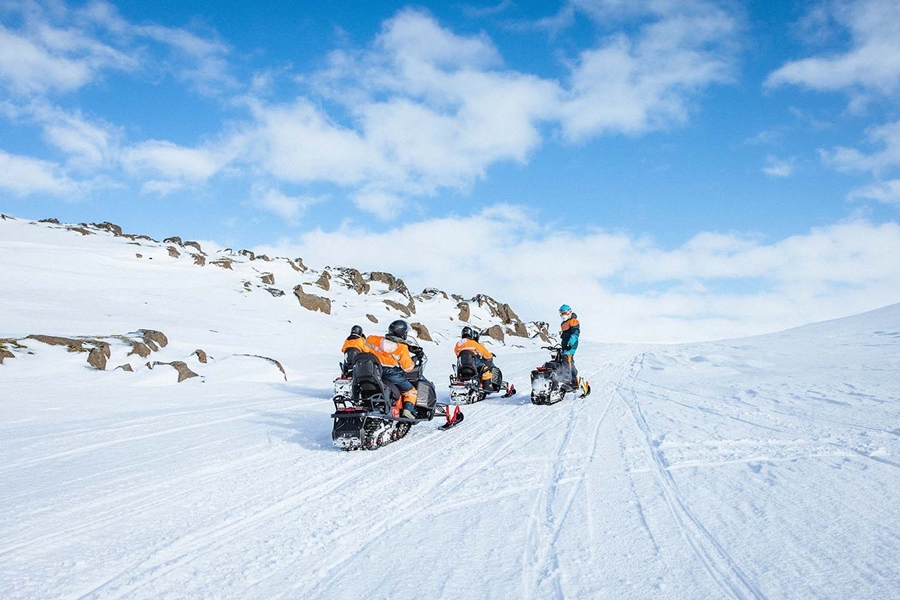 Group snowmobiles on glacier in Iceland