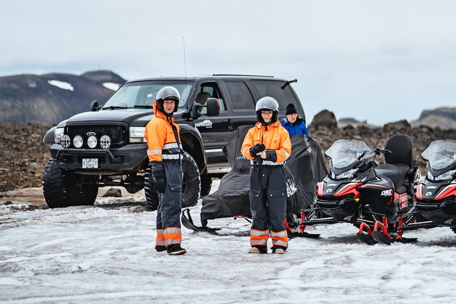 Group of people preparing for the snowmobiling tour