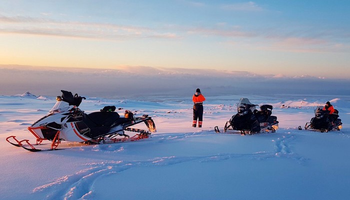 Snowmobiles parked on the glacier