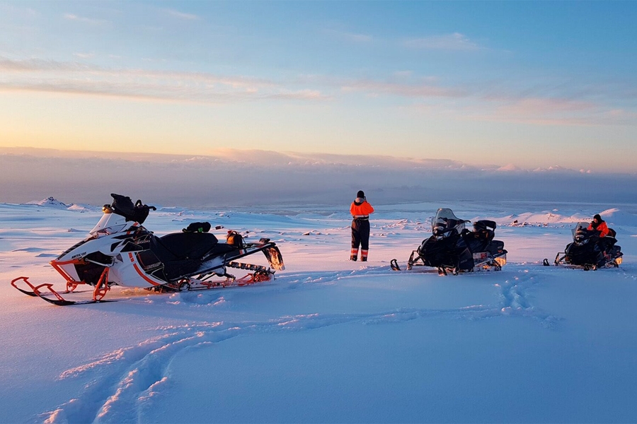 Snowmobiles parked on the glacier
