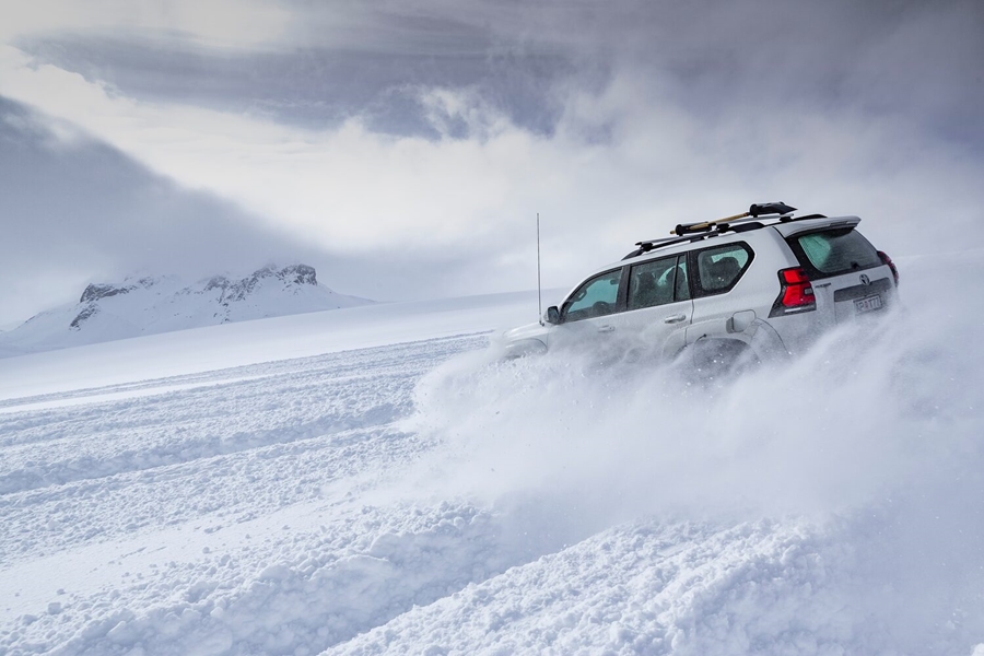 Super jeep driving on snowy glacier
