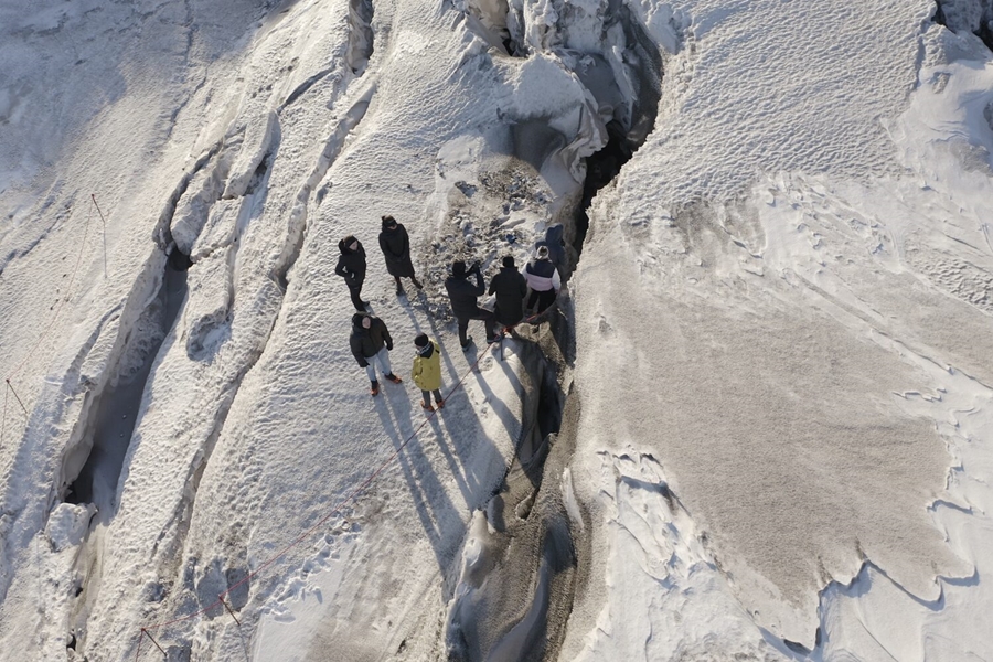 Aerial view of people by ice crack