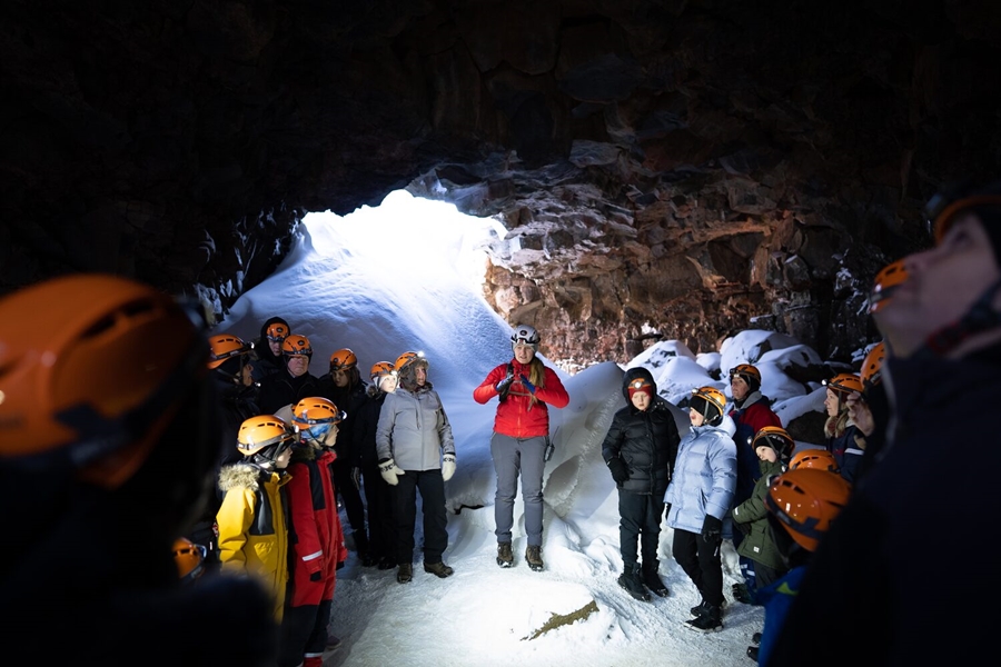 Guide and tour group in lava tube