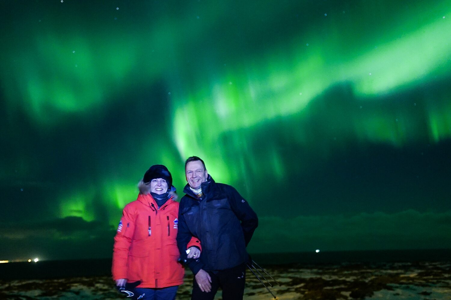 Couple enjoying northern lights watching tour