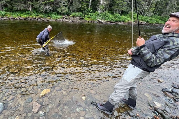Two men fishing salmon in Cascapedia river