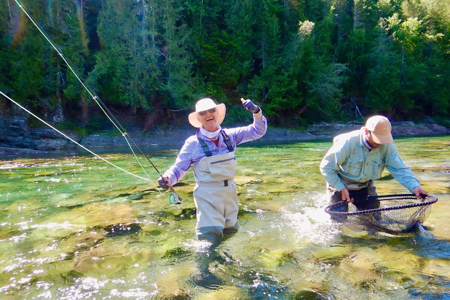 Two fisherman trying to catch salmon in Canadian river