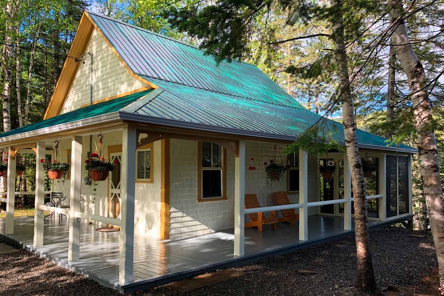 White wooden lodge with green roof in Canada