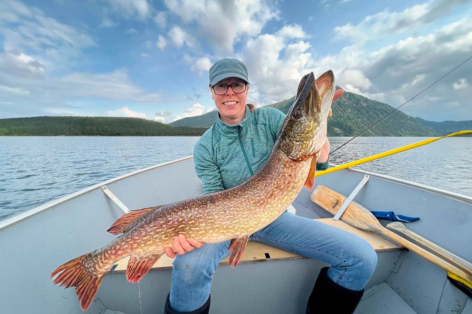 Woman in boat with caught huge fish
