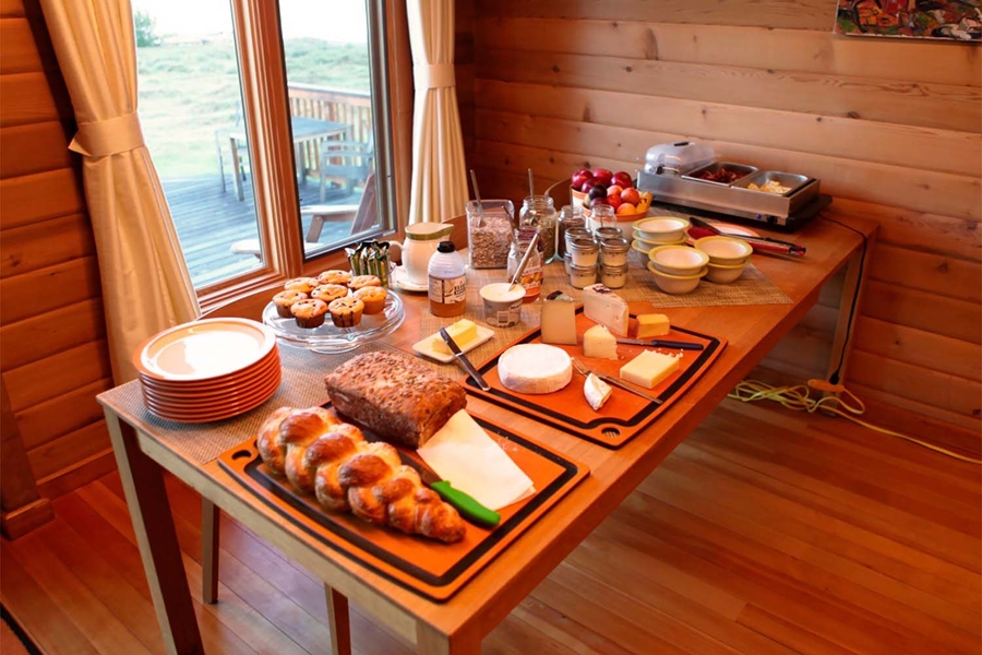 Breakfast table in wooden fishing lodge