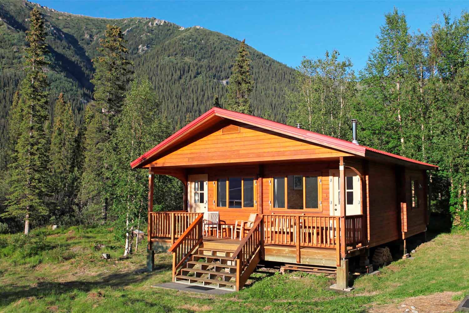 Wooden fishing cabin with red rooftop in Yukon
