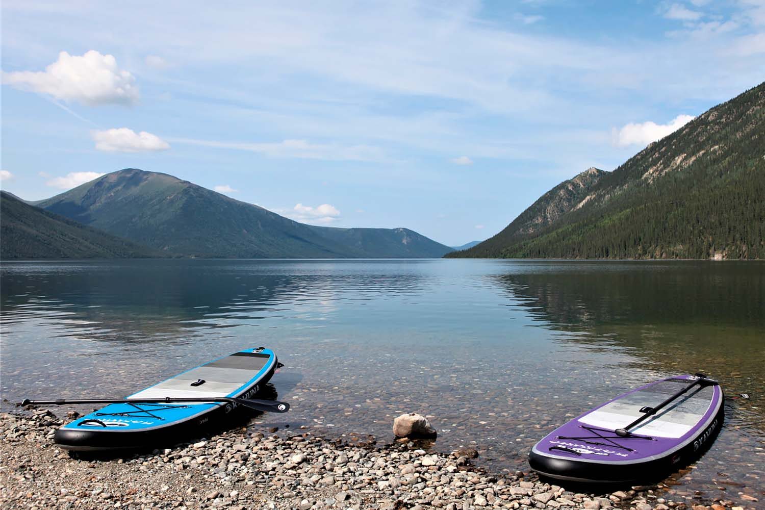 Two sup boards by lake shore in Canada