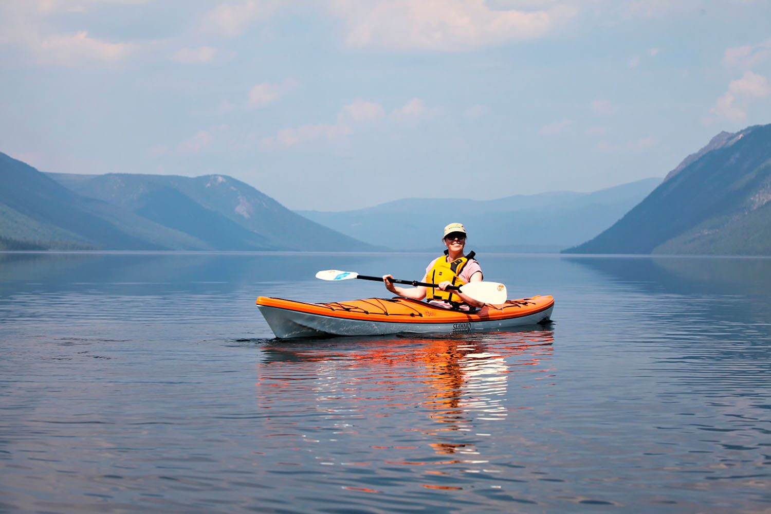 Happy woman kayaking in Tincup lake