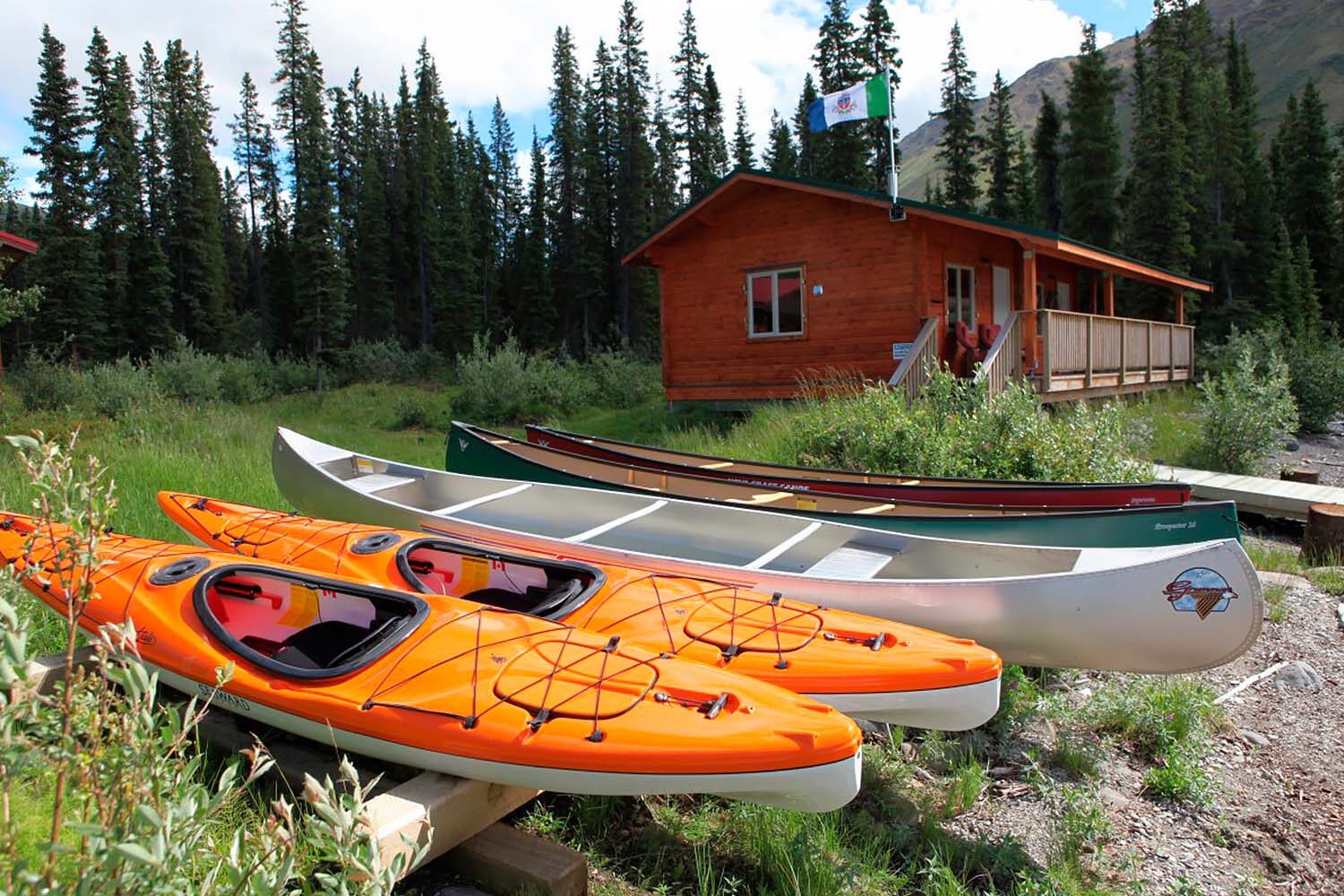 Kayaks and canoes by wooden lodge in Canada