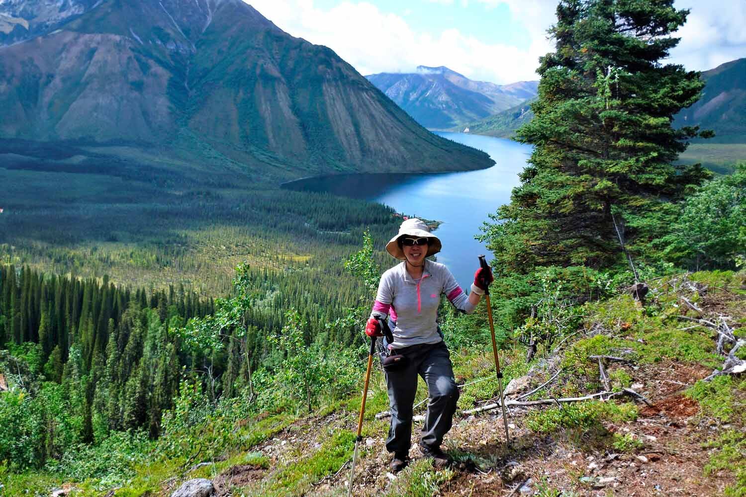 Woman hiking by Tincup lake in Yukon