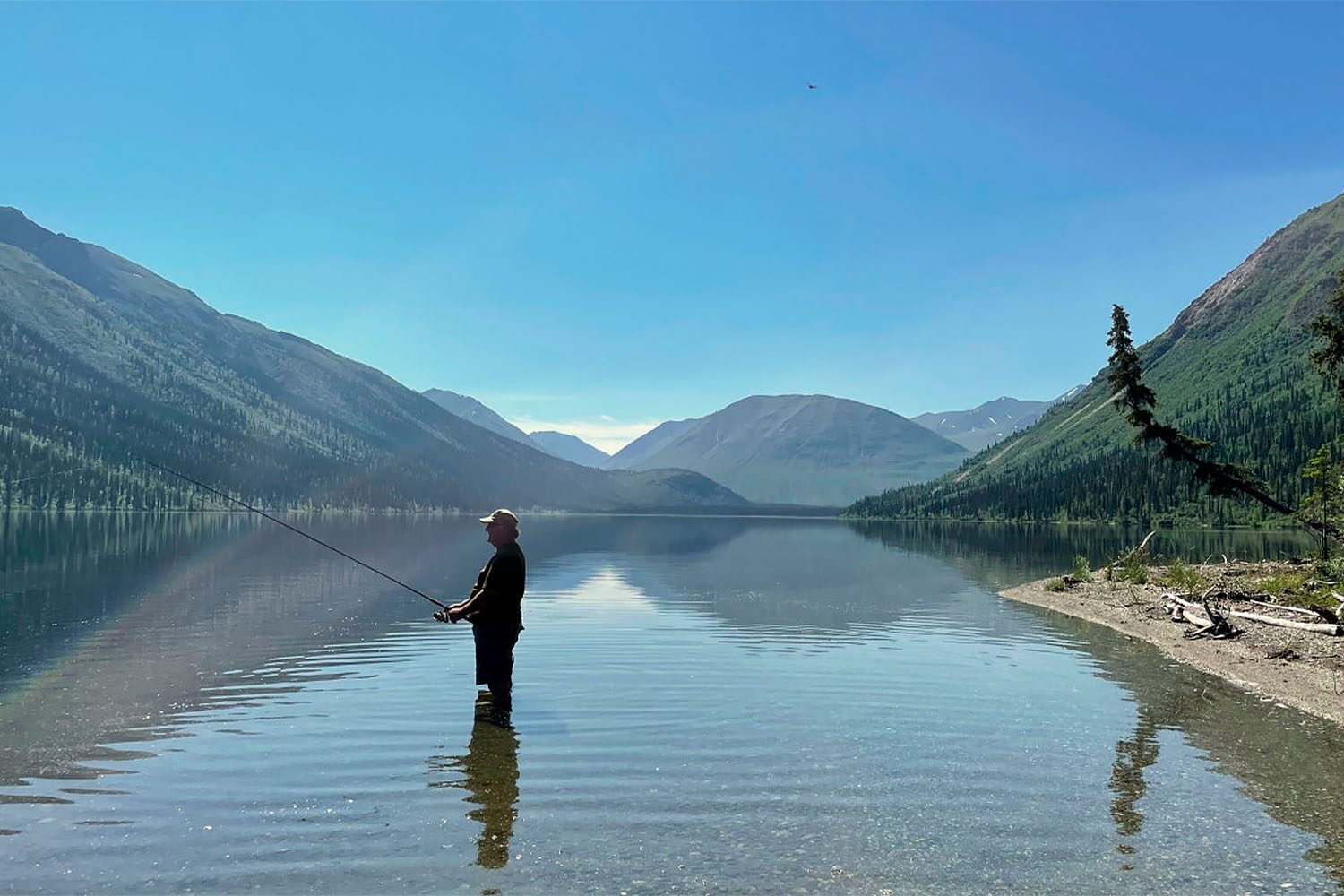 Man standing in Tincup lake and fishing
