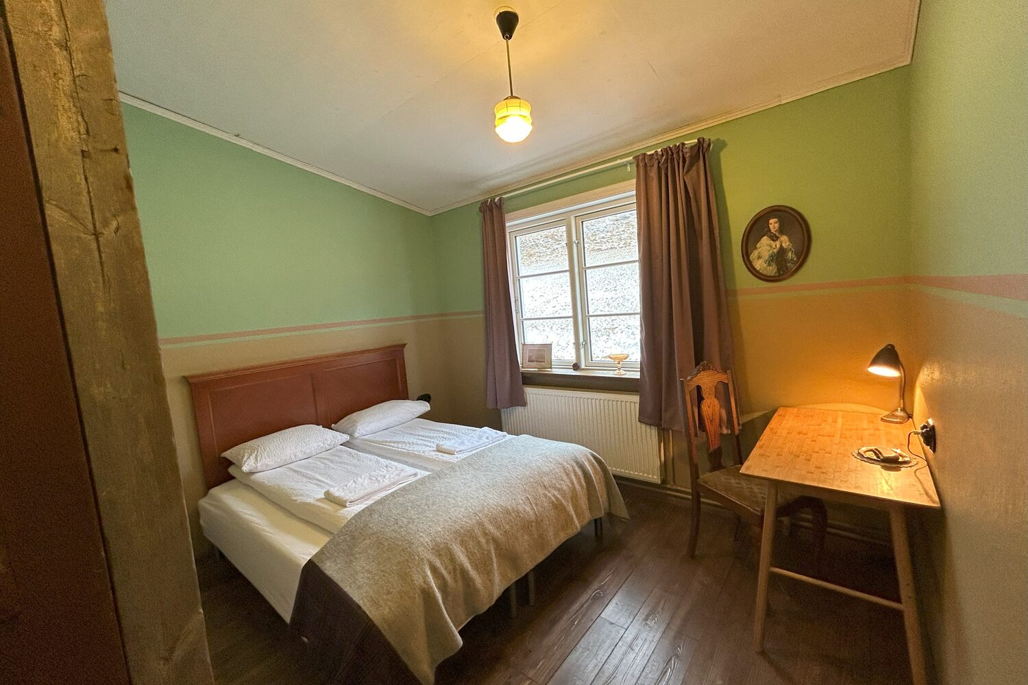 Double bed at hotel room in wilderness center accommodation.