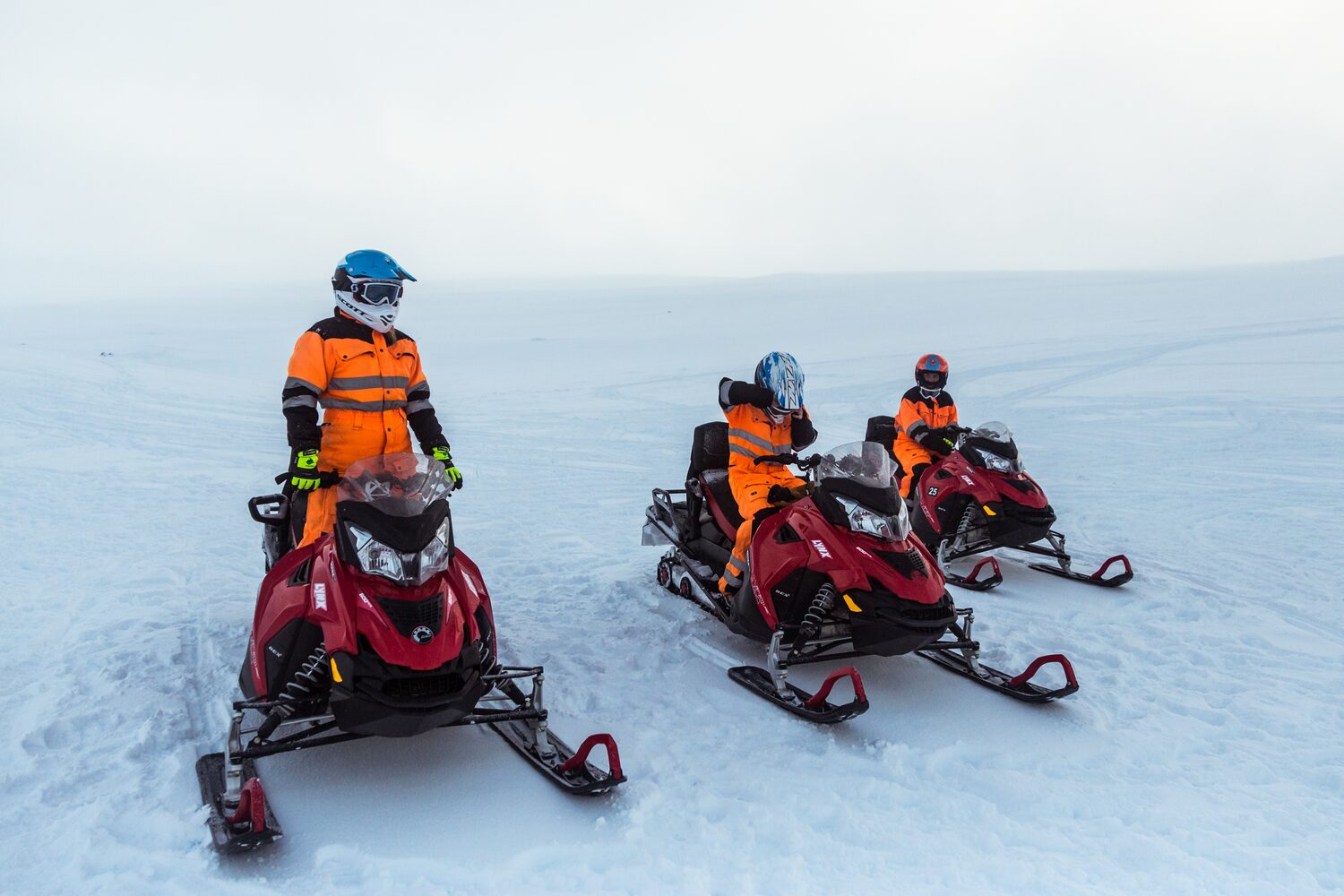 Three Snowmobilers Parked