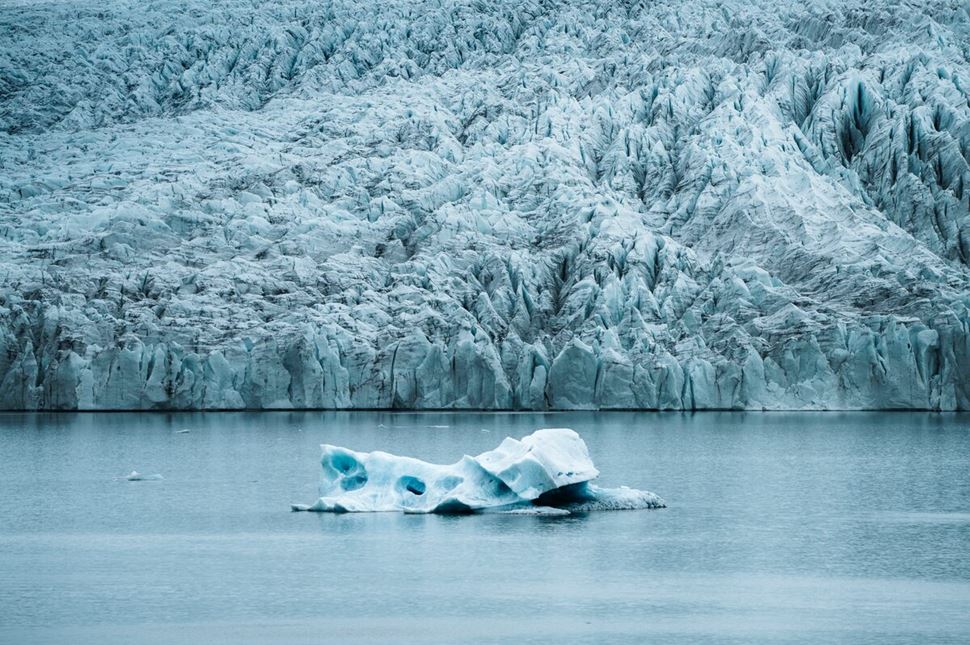 Iceberg in lagoon by huge glacier in Iceland