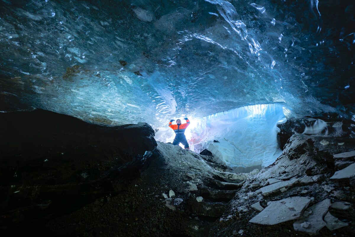Woman in crystal blue ice cave