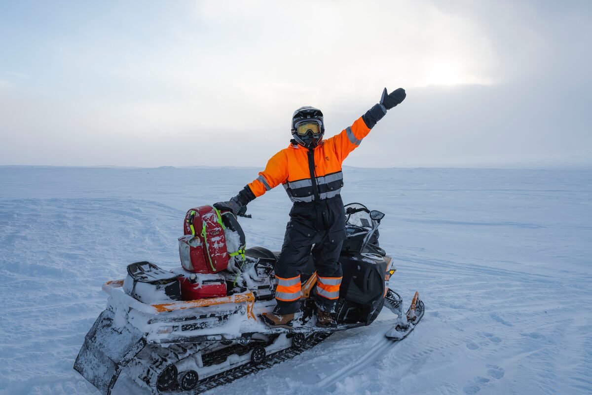 Woman on snowmobile posing for photo