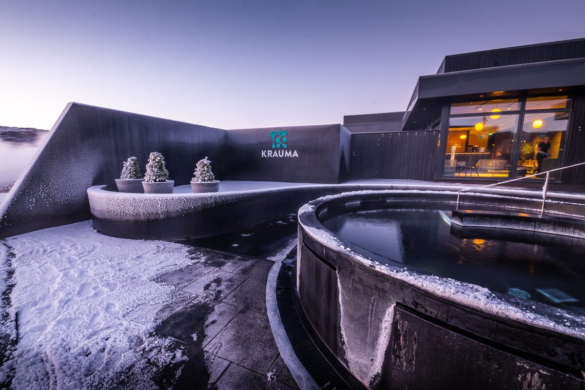 Krauma geothermal bath and spa outside pool and building in winter snow covered