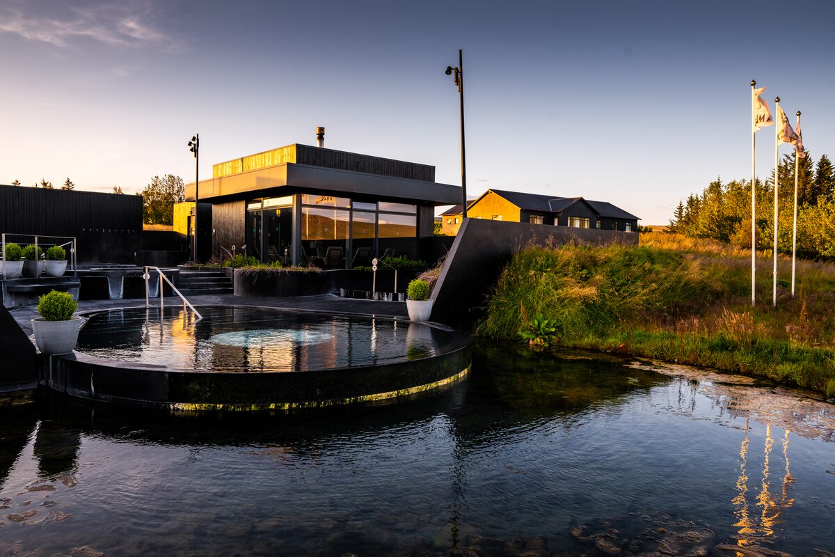 Landscape view of geothermal pools at Krauma during golden sunset