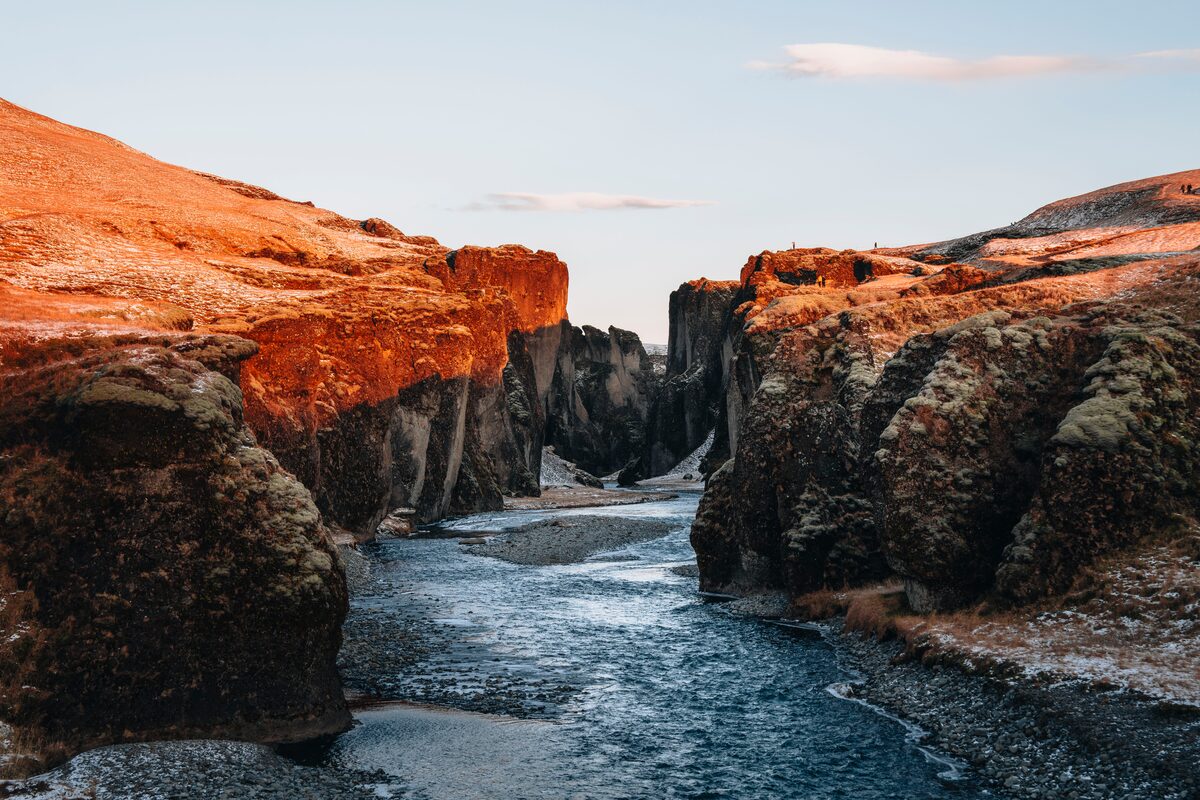 River flowing in between beautiful Icelandic canyon during golden sunset 